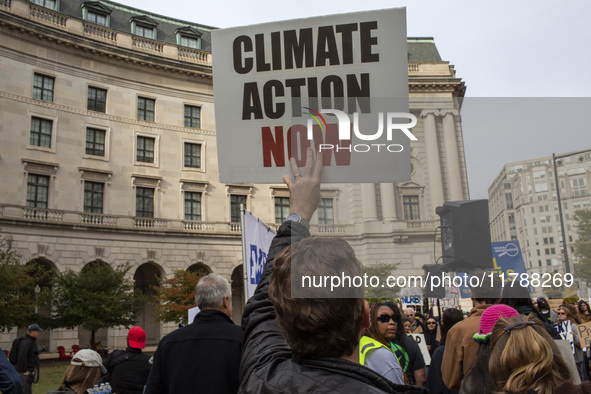 Environmental activists rally to demand climate action before US President-elect Donald Trump takes office in Washington, DC, on November 17...