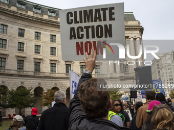 Environmental activists rally to demand climate action before US President-elect Donald Trump takes office in Washington, DC, on November 17...