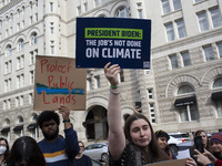 Environmental activists rally to demand climate action before US President-elect Donald Trump takes office in Washington, DC, on November 17...