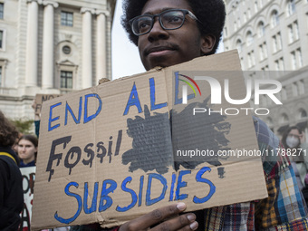 Environmental activists rally to demand climate action before US President-elect Donald Trump takes office in Washington, DC, on November 17...