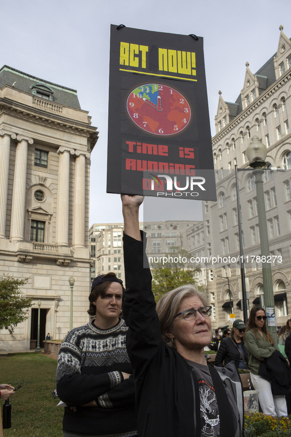 Environmental activists rally to demand climate action before US President-elect Donald Trump takes office in Washington, DC, on November 17...