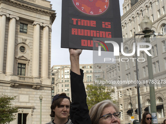 Environmental activists rally to demand climate action before US President-elect Donald Trump takes office in Washington, DC, on November 17...