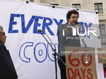 A climate protester gives a speech while environmental activists demonstrate outside the Federal Triangle Metro Station in Washington DC, US...