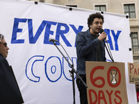 A climate protester gives a speech while environmental activists demonstrate outside the Federal Triangle Metro Station in Washington DC, US...