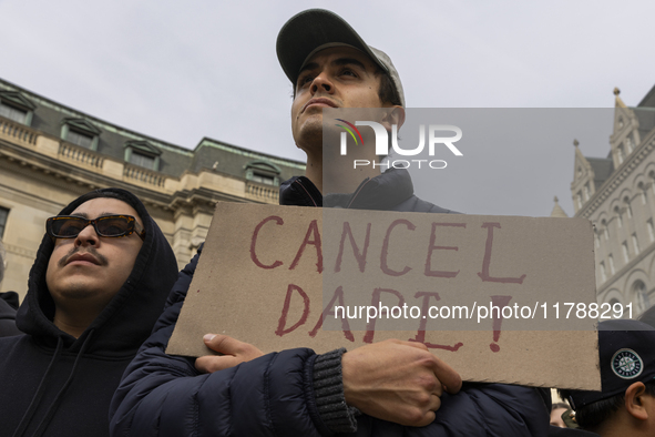 A climate protester holds a sign while environmental activists demonstrate outside the Federal Triangle Metro Station in Washington DC, USA,...