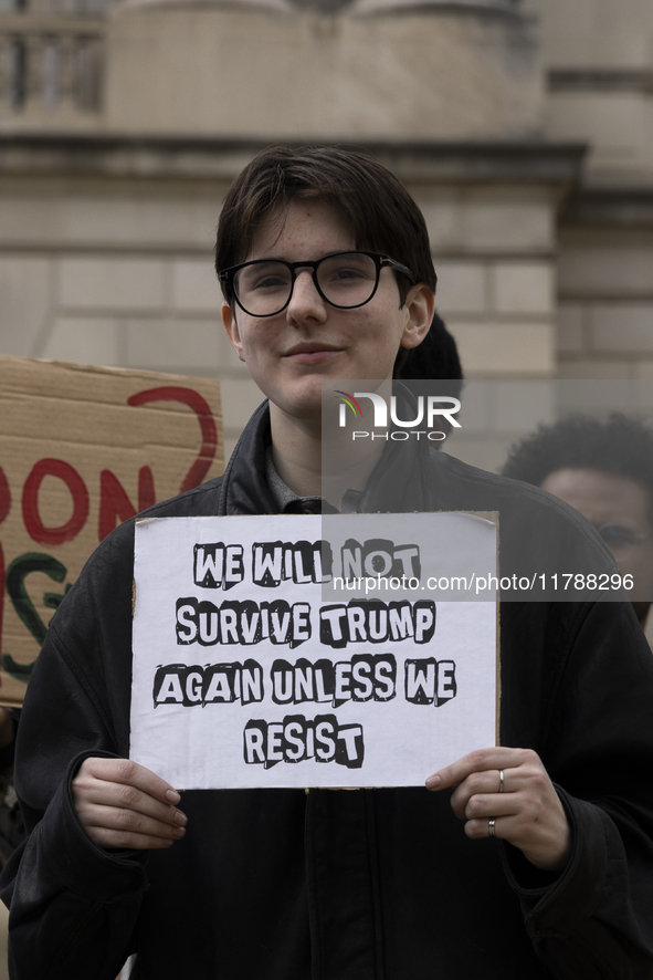 A climate protester holds a sign while environmental activists demonstrate outside the Federal Triangle Metro Station in Washington DC, USA,...