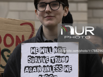 A climate protester holds a sign while environmental activists demonstrate outside the Federal Triangle Metro Station in Washington DC, USA,...