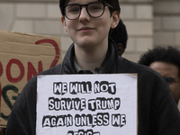 A climate protester holds a sign while environmental activists demonstrate outside the Federal Triangle Metro Station in Washington DC, USA,...