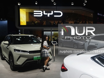 Visitors visit BYD's stand at the Guangzhou Auto Show 2024 in Guangzhou, Guangdong, China, on November 15, 2024. China's new energy vehicle...