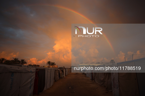 A rainbow arches across the sky above the tents of internally displaced persons who flee the Israeli military bombing and incursion in the n...