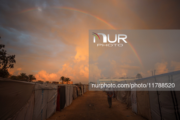 A displaced Palestinian man walks among the tents of internally displaced persons who flee the Israeli military bombing and incursion in the...