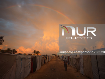 A displaced Palestinian man walks among the tents of internally displaced persons who flee the Israeli military bombing and incursion in the...