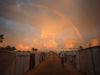 A displaced Palestinian man walks among the tents of internally displaced persons who flee the Israeli military bombing and incursion in the...