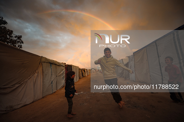 Palestinian children play among the tents of internally displaced persons who flee the Israeli military bombing and incursion in the norther...