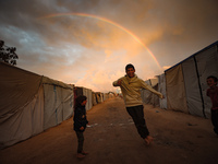 Palestinian children play among the tents of internally displaced persons who flee the Israeli military bombing and incursion in the norther...