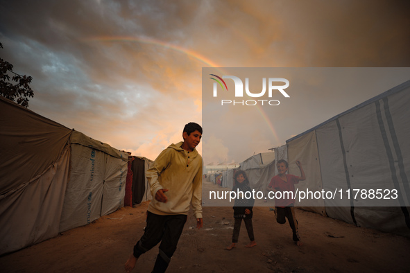 Palestinian children play among the tents of internally displaced persons who flee the Israeli military bombing and incursion in the norther...