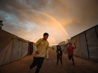 Palestinian children play among the tents of internally displaced persons who flee the Israeli military bombing and incursion in the norther...