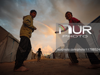 Palestinian children play among the tents of internally displaced persons who flee the Israeli military bombing and incursion in the norther...