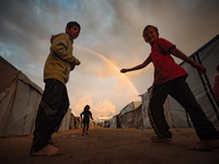 Palestinian children play among the tents of internally displaced persons who flee the Israeli military bombing and incursion in the norther...