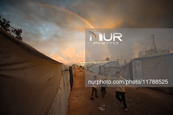 Palestinian children play among the tents of internally displaced persons who flee the Israeli military bombing and incursion in the norther...