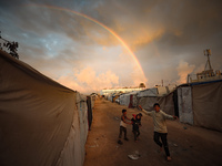 Palestinian children play among the tents of internally displaced persons who flee the Israeli military bombing and incursion in the norther...