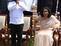 Sri Lankan president Anura Kumara Dissanayake acknowledges the supporters as Prime Minister Harini Amarasuriya looks on with newly appointed...