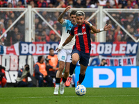 Ivan Leguizamon of San Lorenzo competes for the ball against Gaston Martirena of Racing Club during a Liga Profesional 2024 match between Sa...