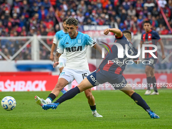 Elias Baez of San Lorenzo competes for the ball against Gaston Martirena of Racing Club during a Liga Profesional 2024 match between San Lor...