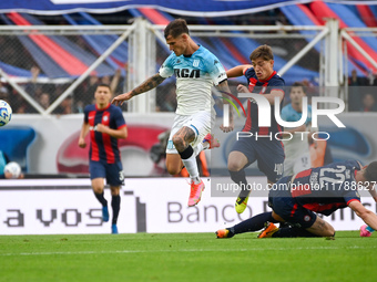 Gaston Campi of San Lorenzo competes for the ball against Bruno Zuculini of Racing Club during a Liga Profesional 2024 match between San Lor...