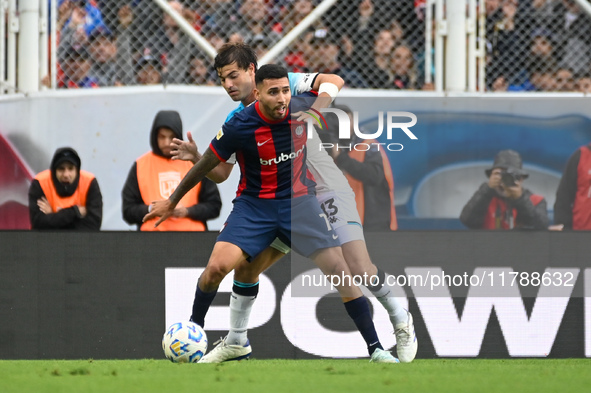 Nahuel Bustos of San Lorenzo competes for the ball against Santiago Sosa of Racing Club during a Liga Profesional 2024 match between San Lor...