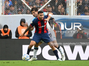 Nahuel Bustos of San Lorenzo competes for the ball against Santiago Sosa of Racing Club during a Liga Profesional 2024 match between San Lor...