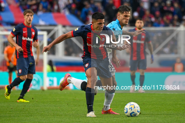 Alexis Cuello of San Lorenzo competes for the ball against Bruno Zuculini of Racing Club during a Liga Profesional 2024 match between San Lo...