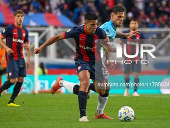 Alexis Cuello of San Lorenzo competes for the ball against Bruno Zuculini of Racing Club during a Liga Profesional 2024 match between San Lo...