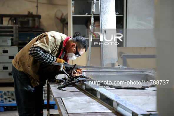 A worker produces intelligent devices in a manufacturing workshop in Binzhou City, Shandong Province, China, on November 18, 2024. 