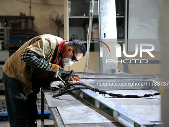 A worker produces intelligent devices in a manufacturing workshop in Binzhou City, Shandong Province, China, on November 18, 2024. (