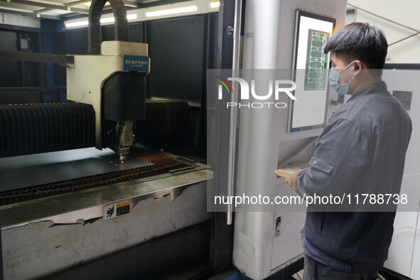 A worker produces intelligent devices in a manufacturing workshop in Binzhou City, Shandong Province, China, on November 18, 2024. 