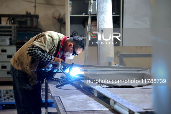 A worker produces intelligent devices in a manufacturing workshop in Binzhou City, Shandong Province, China, on November 18, 2024. 