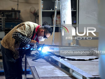 A worker produces intelligent devices in a manufacturing workshop in Binzhou City, Shandong Province, China, on November 18, 2024. (