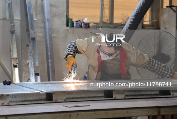 A worker produces intelligent devices in a manufacturing workshop in Binzhou City, Shandong Province, China, on November 18, 2024. 