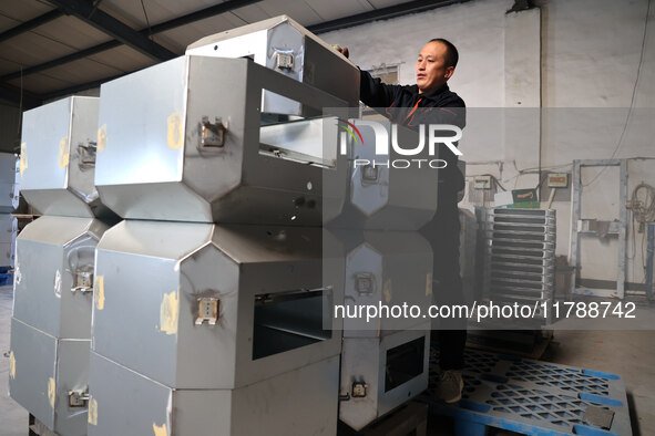 A worker produces intelligent devices in a manufacturing workshop in Binzhou City, Shandong Province, China, on November 18, 2024. 