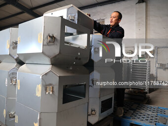 A worker produces intelligent devices in a manufacturing workshop in Binzhou City, Shandong Province, China, on November 18, 2024. (