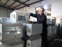 A worker produces intelligent devices in a manufacturing workshop in Binzhou City, Shandong Province, China, on November 18, 2024. (