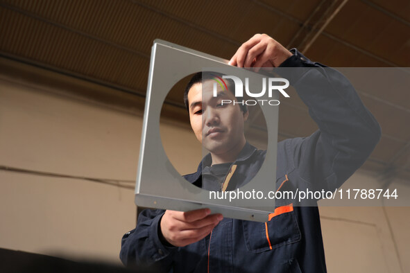 A worker produces intelligent devices in a manufacturing workshop in Binzhou City, Shandong Province, China, on November 18, 2024. 