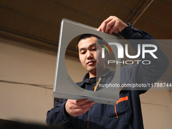 A worker produces intelligent devices in a manufacturing workshop in Binzhou City, Shandong Province, China, on November 18, 2024. (