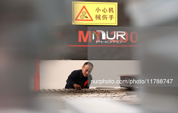 A worker produces intelligent devices in a manufacturing workshop in Binzhou City, Shandong Province, China, on November 18, 2024. 