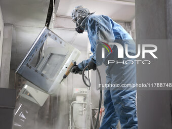 A worker produces intelligent devices in a manufacturing workshop in Binzhou City, Shandong Province, China, on November 18, 2024. (