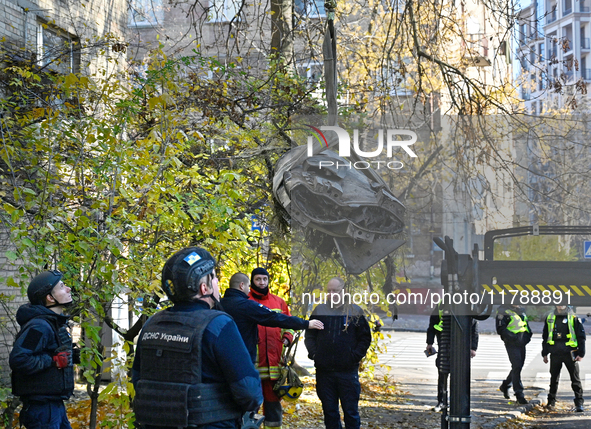 In Kyiv, Ukraine, on November 17, 2024, workers of the State Emergency Service and forensic experts examine part of a Russian missile that h...