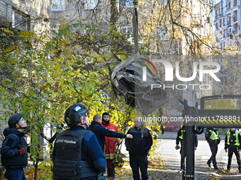 In Kyiv, Ukraine, on November 17, 2024, workers of the State Emergency Service and forensic experts examine part of a Russian missile that h...