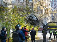 In Kyiv, Ukraine, on November 17, 2024, workers of the State Emergency Service and forensic experts examine part of a Russian missile that h...