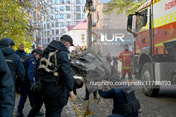 In Kyiv, Ukraine, on November 17, 2024, workers of the State Emergency Service and forensic experts examine part of a Russian missile that h...